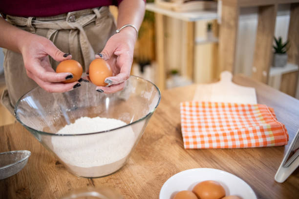 istock A young beautiful woman is preparing pancakes 1569365817