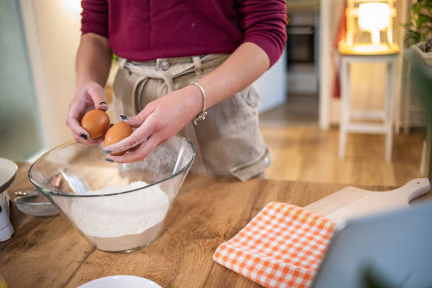 istock A young beautiful woman is preparing pancakes 1569368464