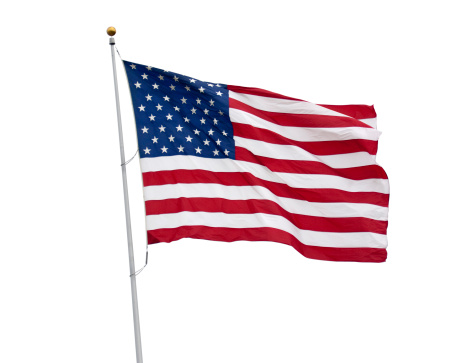 An American flag flying in the breeze isolated on white with a clipping path