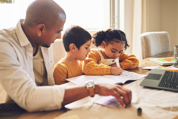 istock Writing, learning and father with children for home education, school development and support or helping. Books, Knowledge and language translation or math notes with family or dad teaching kids 1569378863