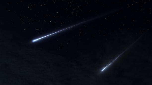 istock Meteors light up the sky. Meteor trails on a black background. 1569385947
