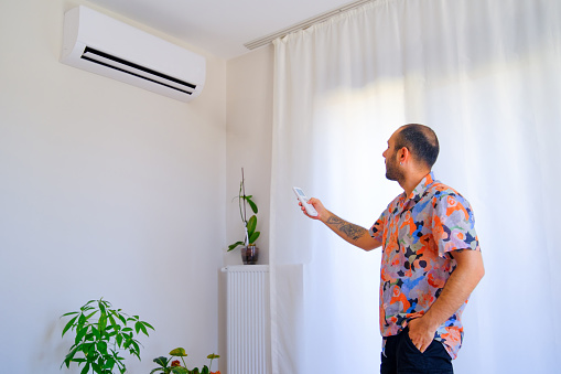 Running the air conditioner in economy mode to save energy at home