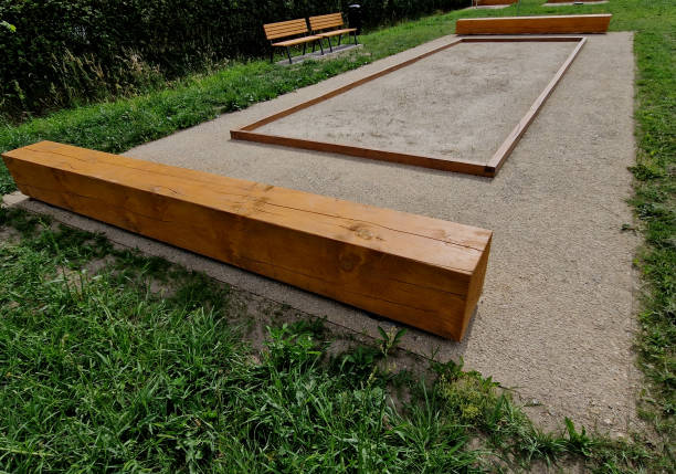It is recommended to demarcate the playground behind the area of ​​loss with wooden barriers, telegraph poles, sleepers, wooden barriers are better than concrete ones. Better cushions ball impacts. Flat sandy or fine gravel, a patch, at least 12 meters long, will serve as a playground. In addition, pétanque balls are needed that bounce off each other nicely and are marked with notches so that, benches, rectangular leisure activity french culture sport high angle view stock pictures, royalty-free photos & images