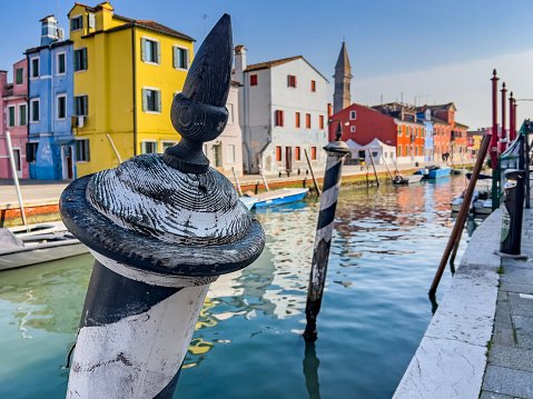 Venice landmark, Burano island canal, colorful houses church and boats, Italy. Long exposure photography