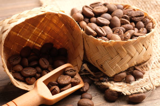 coffee bean is a seed of the Coffea plant and the source for coffee. coffee beans in a woven bamboo container. biji kopi. wooden spoon. coffee bean is a seed of the Coffea plant and the source for coffee. coffee beans in a woven bamboo container. biji kopi biji kopi stock pictures, royalty-free photos & images