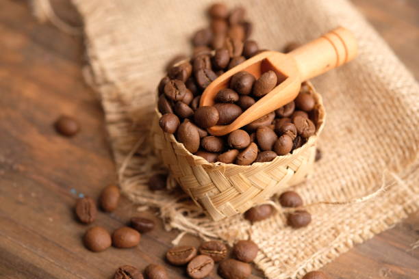 coffee bean is a seed of the Coffea plant and the source for coffee. coffee beans in a woven bamboo container. biji kopi. wooden spoon. coffee bean is a seed of the Coffea plant and the source for coffee. coffee beans in a woven bamboo container. biji kopi biji kopi stock pictures, royalty-free photos & images