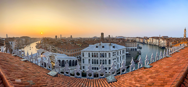 Breathtaking view, picturesque scene of the famous Grand Canal from the roof terrase of T Fondaco Dei Tedeschi mall next to the Rialto bridge at sunset. Beautiful high angle shot of Venice, in Italy. Travel destination background with copy space.