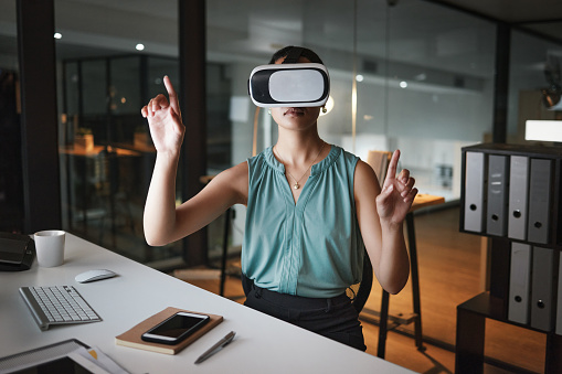 Vr, metaverse and business woman in virtual reality exploring cyber world in office at night. Futuristic, technology and female employee with digital headset with ai software for 3d internet browsing