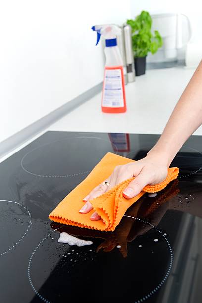 istock Hand cleaning induction stove 156943409
