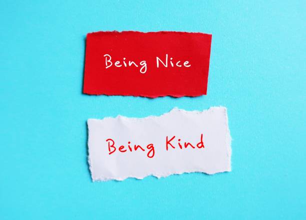 istock Torn paper on blue copy space background with handwriting BEING NICE, changed or BEING KIND, to stop being People Pleaser, prioritize self-respect and start being kind instead 1569435221