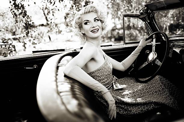 istock Smiling retro woman in convertible 156944324