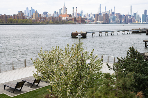 Roosevelt Island, New York February 1, 2023.  A very brief snowy day in Roosevelt Island.  Within 3 hours only the snow was melted on a morning of February 2023.  View from Roosevelt Island towards Long Island City and Manhattan skyline.