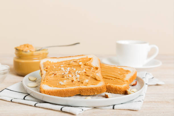 Peanut butter sandwiches or toasts on light table background.Breakfast. Vegetarian food. American cuisine top view vith copy space