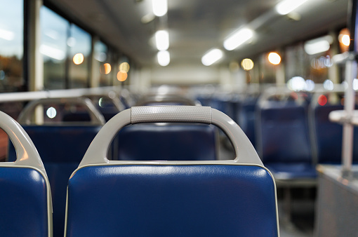 Image with the interior of a german modern train, with no people on the blue chairs