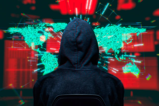 Computer Hacker with world map hologram on surveillance system stock photo