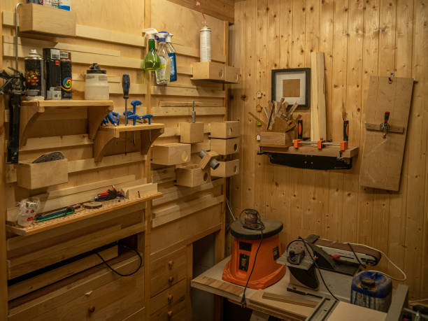 istock Carpentry workshop. On the wall are shelves with various tools and equipment. 1569517801
