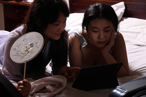Asian students studying in dim light