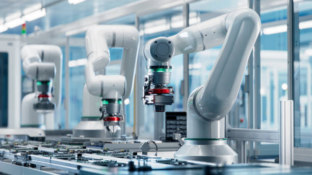 istock Advanced High Precision Robot Arms inside Bright Electronics Factory. Fully Automated Modern PCB Assembly Line. Electronic Devices Production Industry. Quality Control of Circuit Board 1569540475