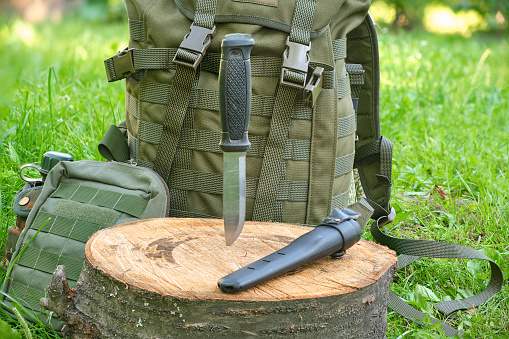 tactical large military knife and military backpack outdoors