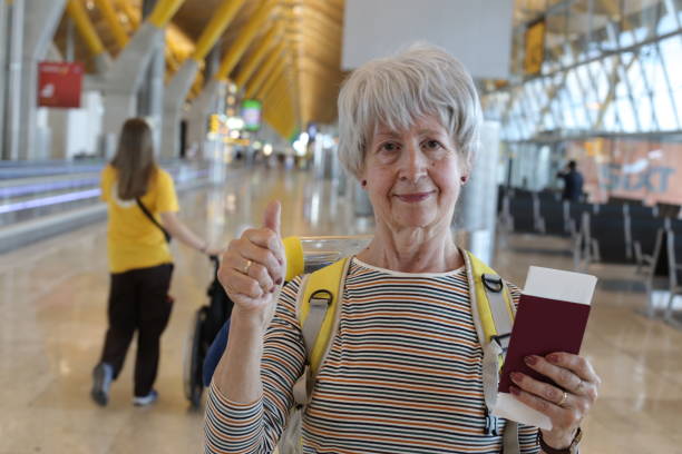 istock Senior traveler giving a thumbs up 1569552367