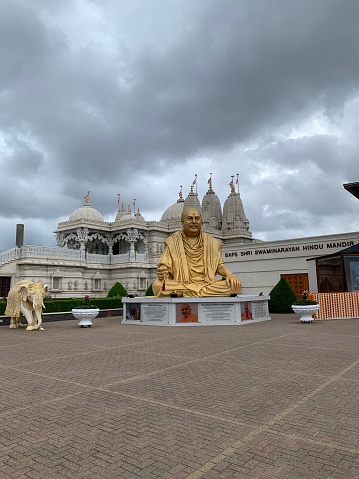BAPS Shri Swaminarayan Mandir  exterior against a nice cloudy sky - built in 1995 it only took 3 years to build and is constructed from Italian Marble, hand carved in India
