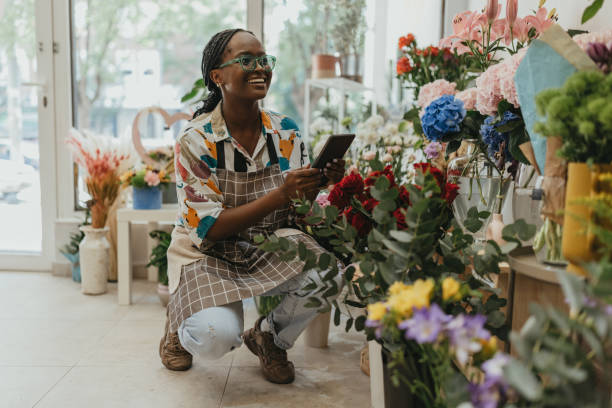 istock Young woman taking inventory in the store 1569566038