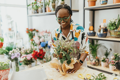Beautiful female working on creating nice flower arrangements. This photo is a part of the day in the life series.