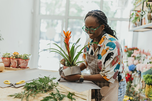 Beautiful female working on creating nice flower arrangements. This photo is a part of the day in the life series.