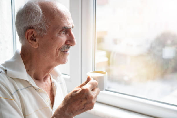 istock The man is drinking coffee looking out the window 1569572533