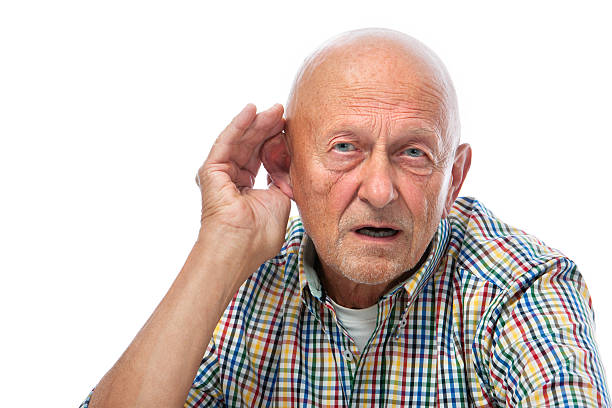 Senior man hard of hearing Senior man cupping his ear having difficulty hearing old man cupping his ear to hear something stock pictures, royalty-free photos & images