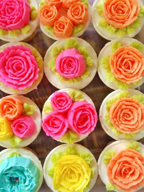 istock Defocused view of colourful cupcakes on display 1569582131