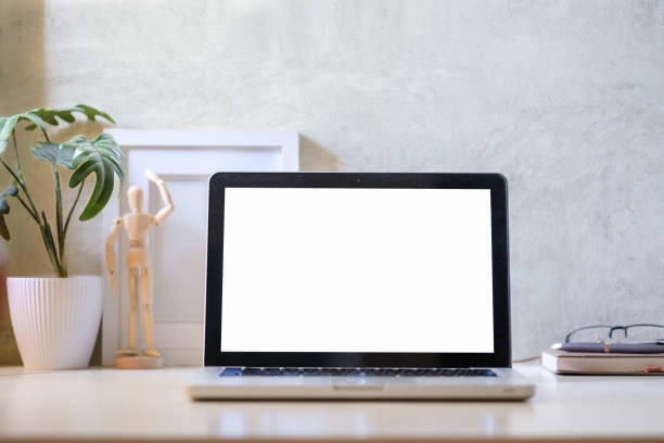 istock Laptop computer, coffee cup, potted plant and picture frame on creative workplace. Blank screen for your advertising text. 1569591331