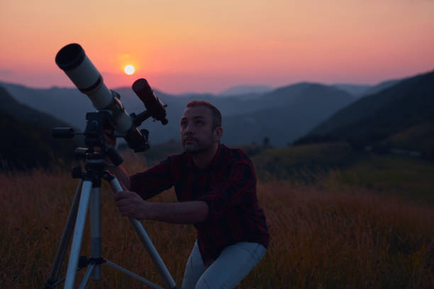 istock Astronomer looking at the skies with a telescope. 1569616397