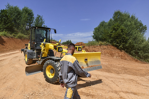Construction Worker Ready To Operate Grader