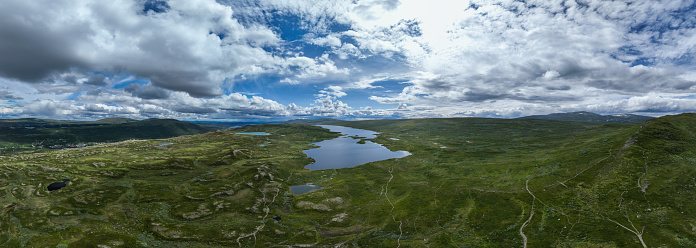 The swan lake seen on top of the Ramundberget mountain in Sweden, Europe during a clody summer day.