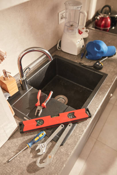 istock Plumber tools for fixing and repairing water tap on the kitchen sink. 1569628371