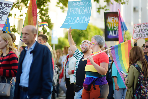Podgorica, Montenegro - October 8, 2022: View of people column during Ten LGBT Pride Parade held in Podgorica, Montenegro. Crowd is on city street with rainbow flag and banners. Fighting for equality