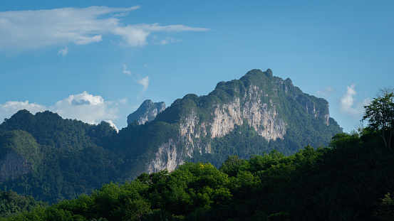 Beautiful view of the greenery mountain range scape in sunny blue sky day. Landscape in nature photo.