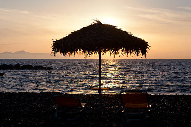 istock One pair of sunchairs at sunset 156963859