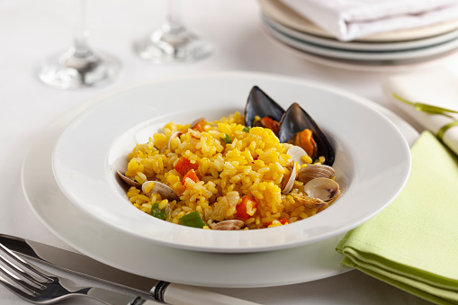 seafood paella in plate on elegant background