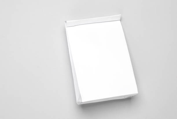 istock White paper lunch bag mockup on gray background. Template for design 1569663719