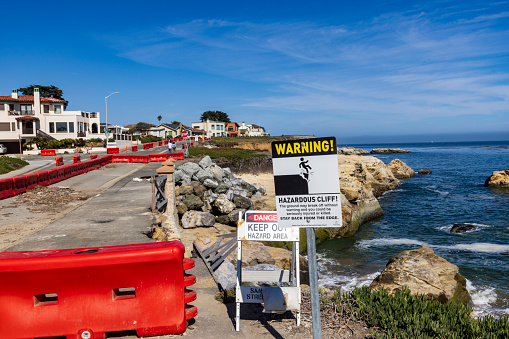 July 25, 2023, West Cliff Drive Santa Cruz:  Status of Storm Damage from January 2023 Storms took out portions of roadway.  Detours continue while city plans for long term repairs.  South facing view of damage with warning sign to walkers.