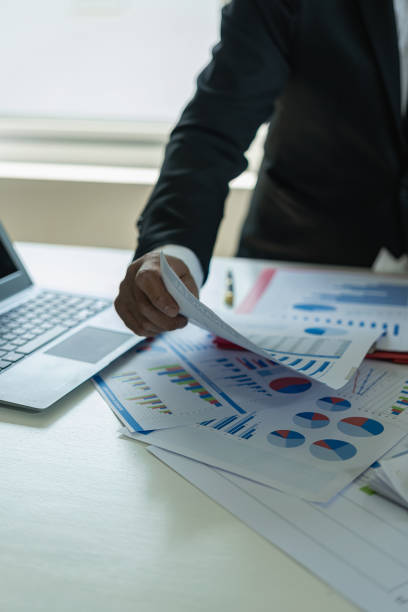 istock vertical image Business financial analyst on investment project planning digital tablet during discussion at corporate meeting showing successful teamwork 1569692280