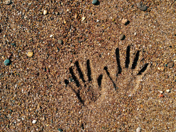 hand imprints in dry cement.