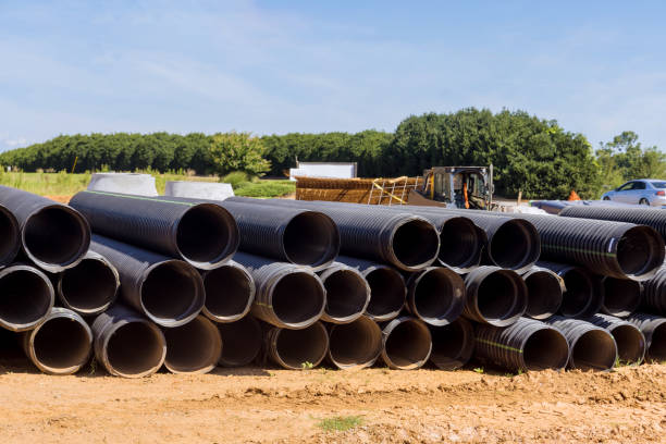 istock Large black plastic pipes for sewerage are stacked on construction site, prepared for installation. 1569695727
