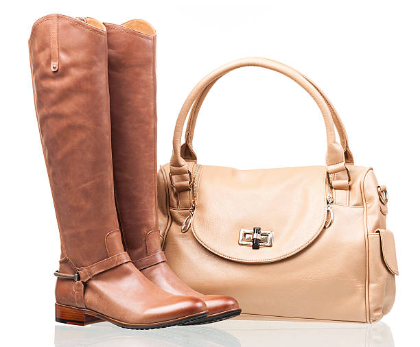 Women knee-high boots and leather bag