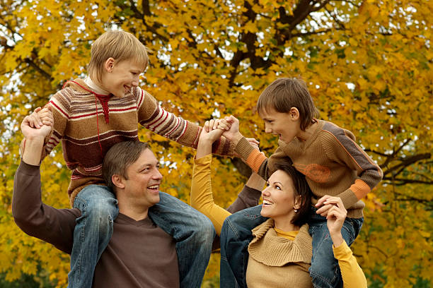 istock family playing in autumn park 156972448