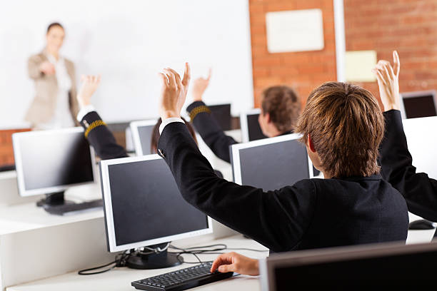 group of high school students hands up group of high school students hands up in computer class high school student child little boys junior high stock pictures, royalty-free photos & images