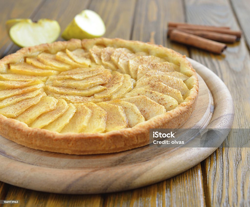 Tart with apples and cinnamon Tart with apples and cinnamon on a brown table Apple Tart Stock Photo