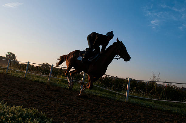istock Jockey riding gallops on track 156974765